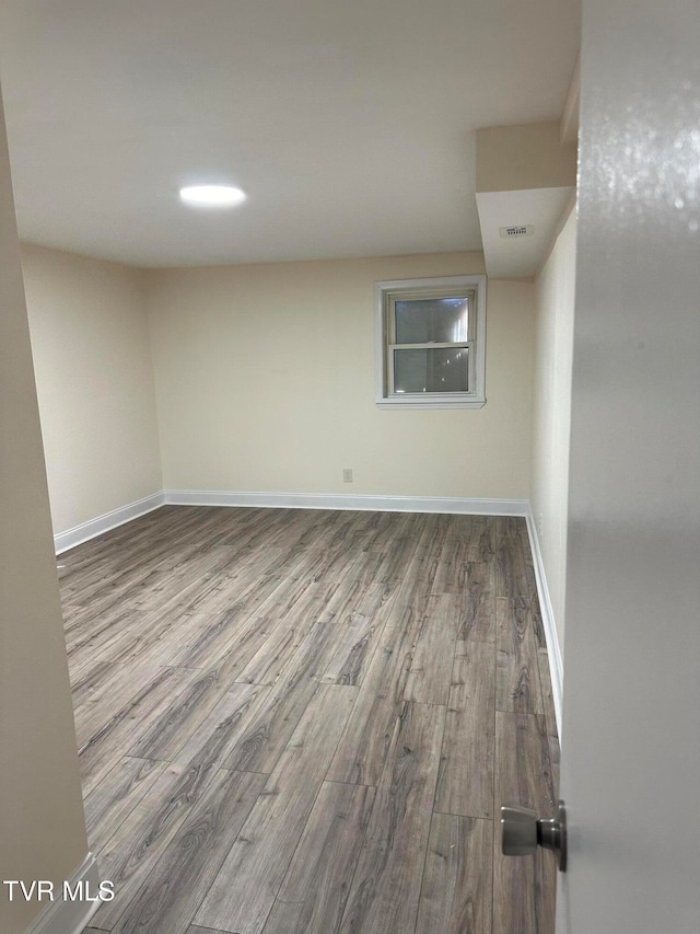 unfurnished room featuring hardwood / wood-style flooring