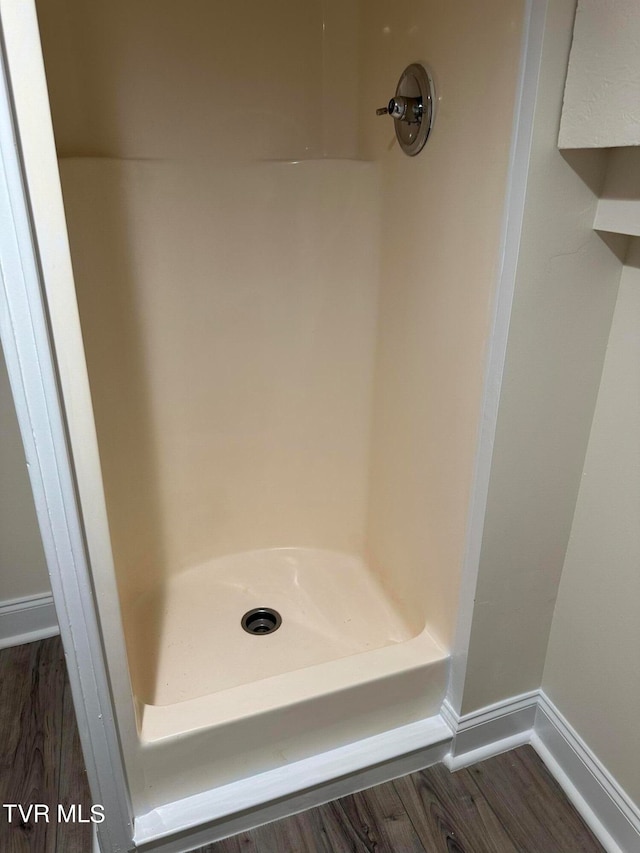 bathroom featuring hardwood / wood-style flooring and a shower