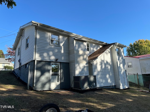 back of property with central AC