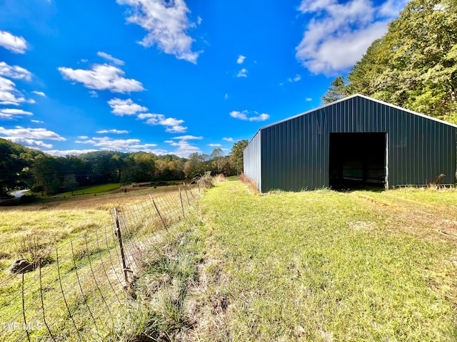 view of outdoor structure with a rural view