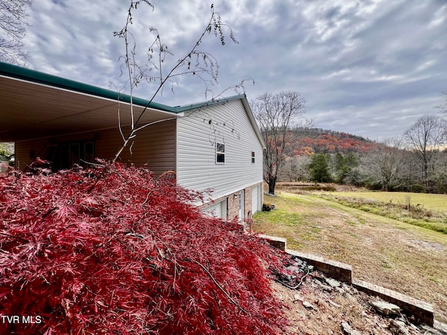 view of side of home featuring a lawn