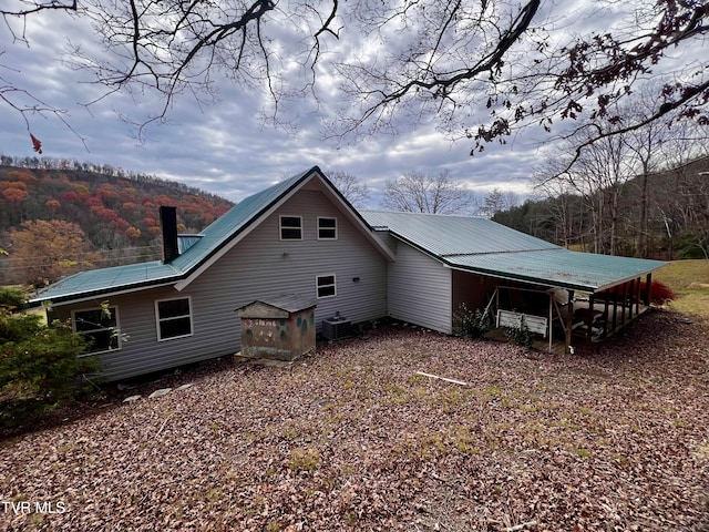 rear view of property featuring central air condition unit