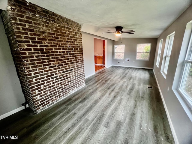 unfurnished living room with hardwood / wood-style flooring, ceiling fan, and a textured ceiling