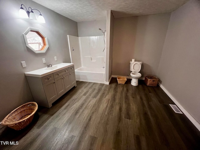 bathroom featuring vanity, wood-type flooring, a textured ceiling, and bathtub / shower combination