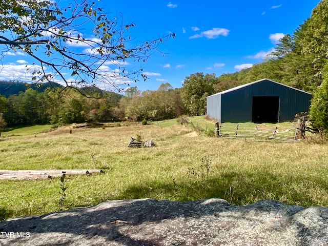 view of yard featuring a rural view and an outdoor structure