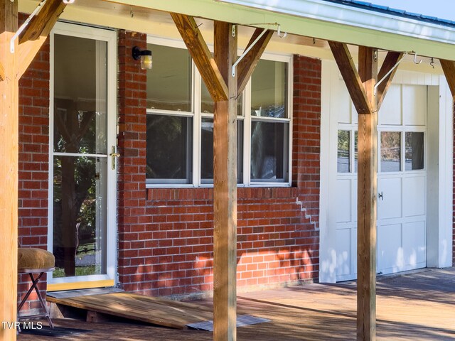 doorway to property featuring a wooden deck