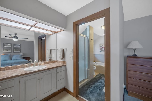 bathroom with ceiling fan, separate shower and tub, and vanity