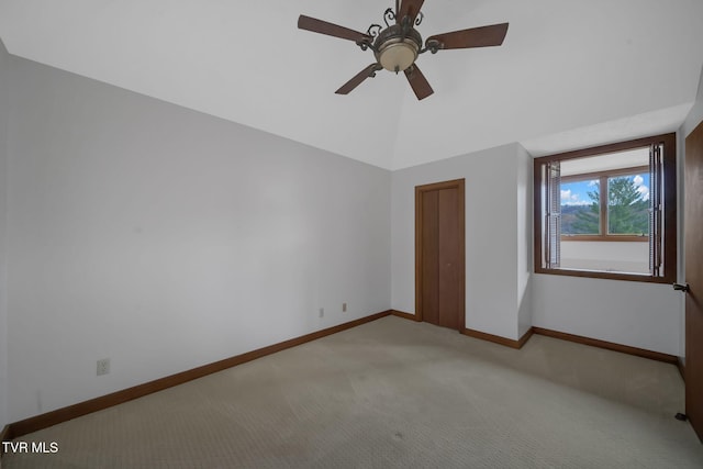 interior space featuring ceiling fan, light colored carpet, and a closet