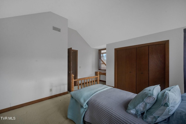 carpeted bedroom with vaulted ceiling and a closet