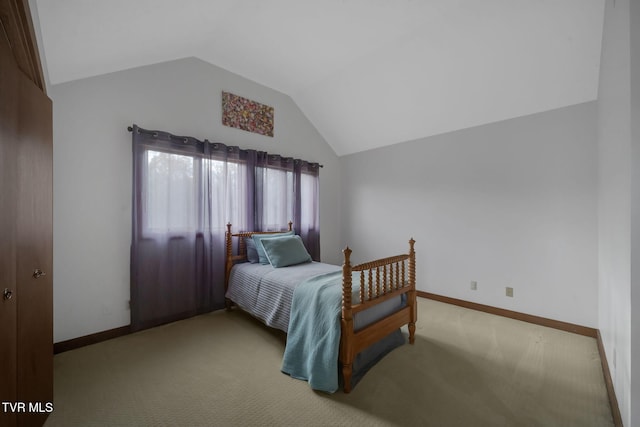 carpeted bedroom with lofted ceiling