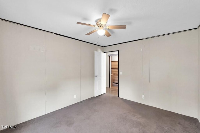 carpeted empty room featuring a ceiling fan