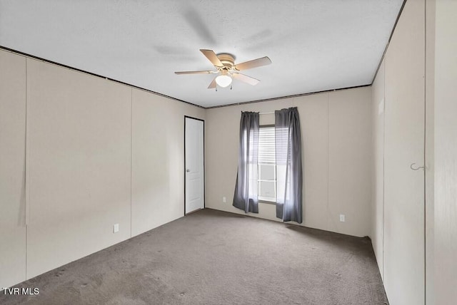 unfurnished bedroom featuring carpet flooring and a ceiling fan