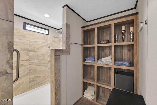 full bath with crown molding, a walk in shower, and a textured ceiling
