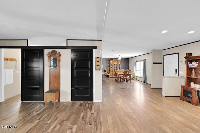 kitchen featuring beamed ceiling, light hardwood / wood-style flooring, and ceiling fan