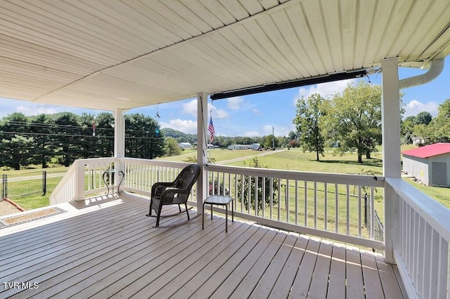 wooden deck featuring a lawn