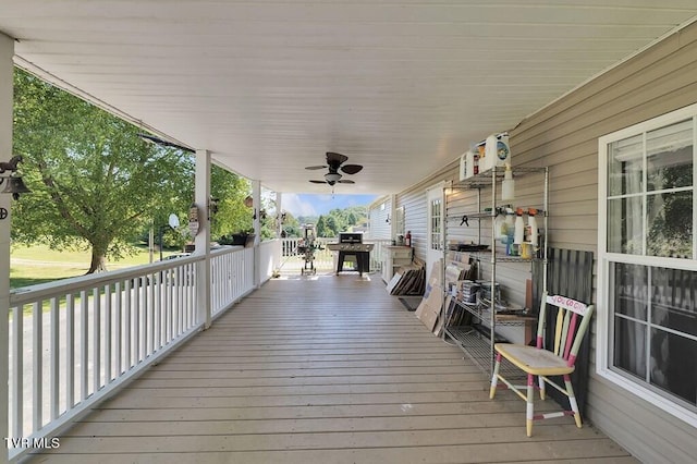 deck with a ceiling fan and covered porch
