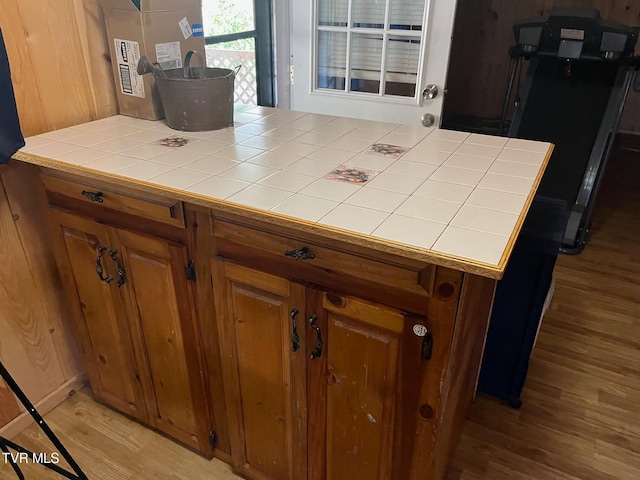 kitchen featuring tile counters and light wood-type flooring