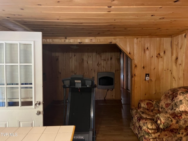 kitchen featuring dark hardwood / wood-style floors, tile counters, wooden ceiling, heating unit, and wood walls