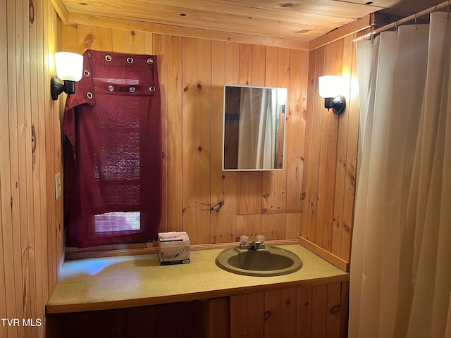 bathroom with vanity and wooden walls