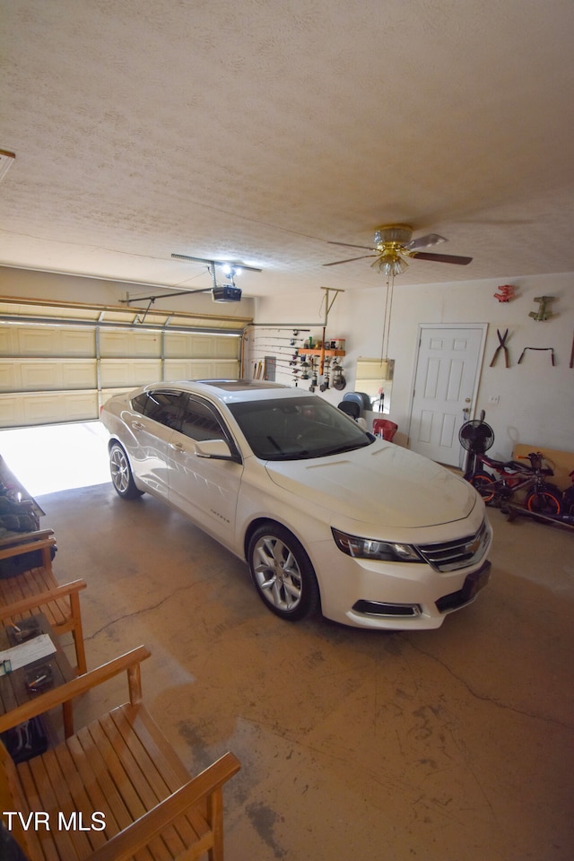 garage with a garage door opener and ceiling fan