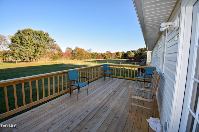 wooden deck featuring a lawn