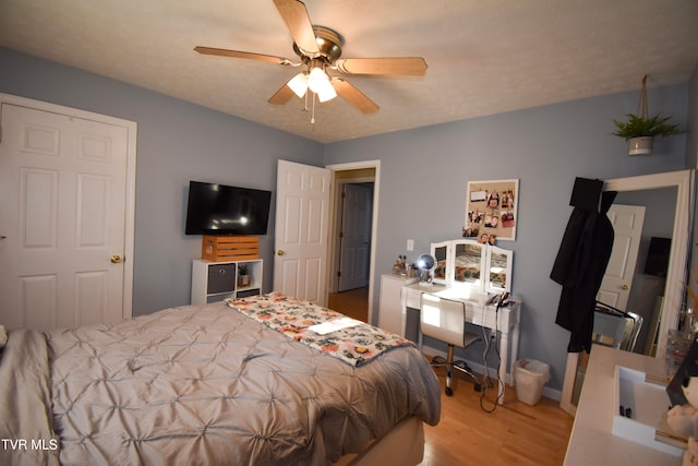 bedroom featuring light wood-type flooring and ceiling fan