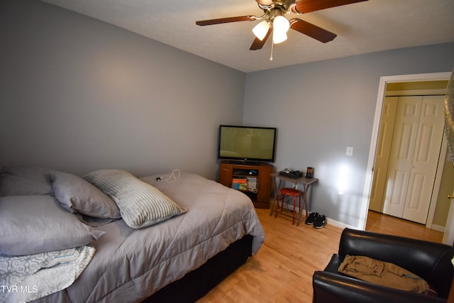 bedroom with light hardwood / wood-style flooring and ceiling fan