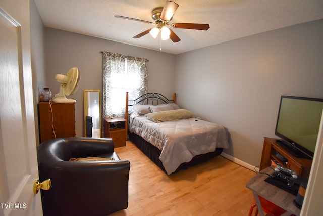 bedroom with light wood-type flooring and ceiling fan