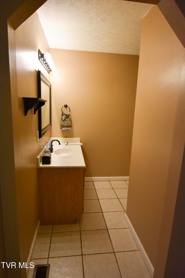 bathroom featuring vanity, a textured ceiling, and tile patterned floors