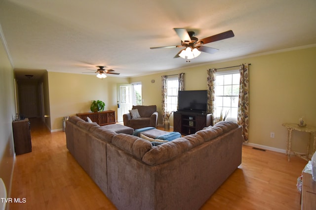 living room with ceiling fan, crown molding, and light hardwood / wood-style flooring