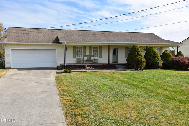 ranch-style house featuring covered porch, a garage, and a front yard