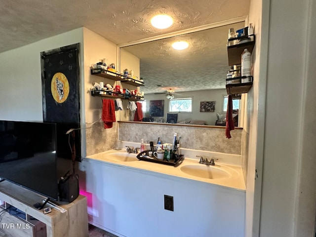 bathroom featuring vanity, a textured ceiling, and ceiling fan