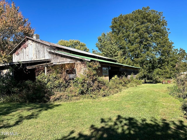 view of property exterior with a yard