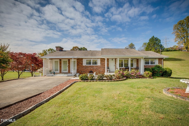 ranch-style home featuring a front yard and covered porch