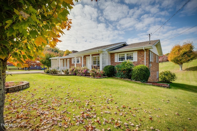 ranch-style home featuring a front yard