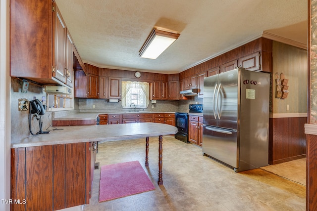 kitchen with sink, ornamental molding, stainless steel fridge, kitchen peninsula, and black range with electric stovetop