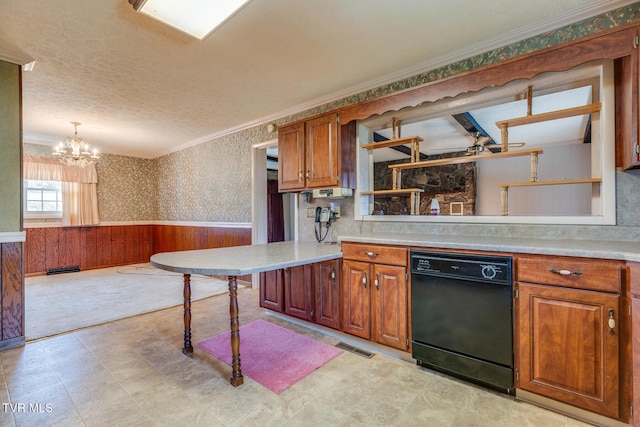 kitchen featuring wooden walls, black dishwasher, a kitchen bar, hanging light fixtures, and kitchen peninsula