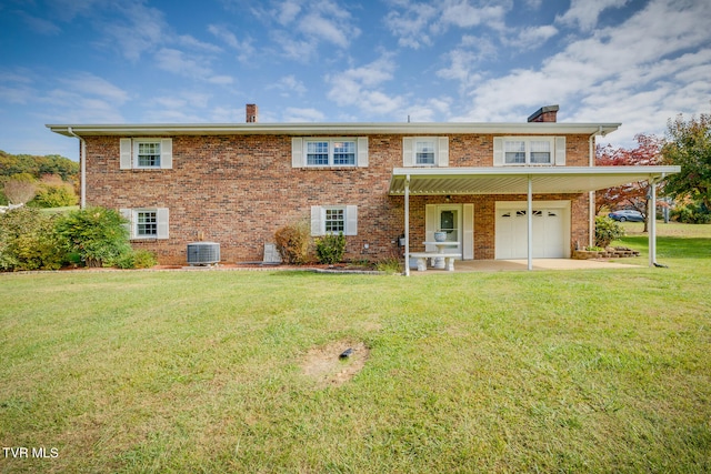 rear view of house with cooling unit, a yard, and a garage