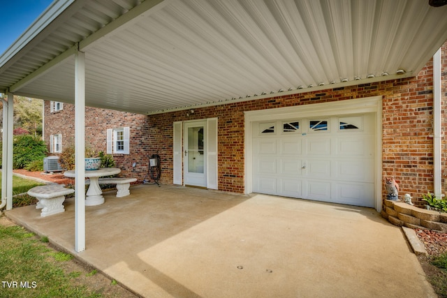 view of patio with a garage and central AC unit