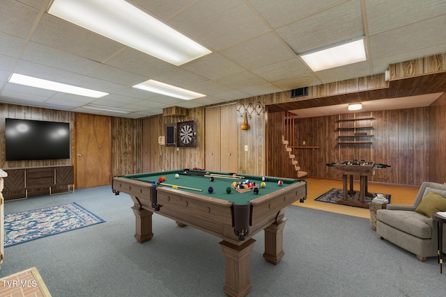 recreation room featuring carpet flooring, a drop ceiling, wood walls, and billiards