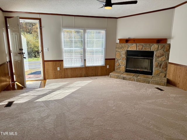 4527 Dorchester Rd, Norton, VA 24273 - unfurnished living room with a wainscoted wall, a textured ceiling, wood walls, ceiling fan, and crown molding