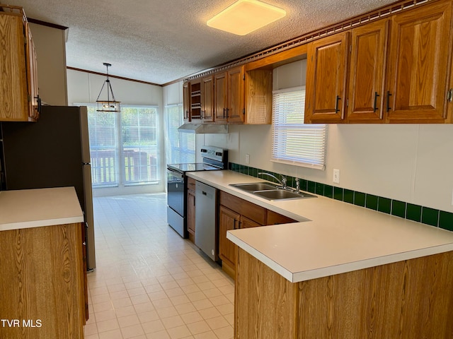 kitchen featuring hanging light fixtures, ornamental molding, sink, appliances with stainless steel finishes, and a textured ceiling