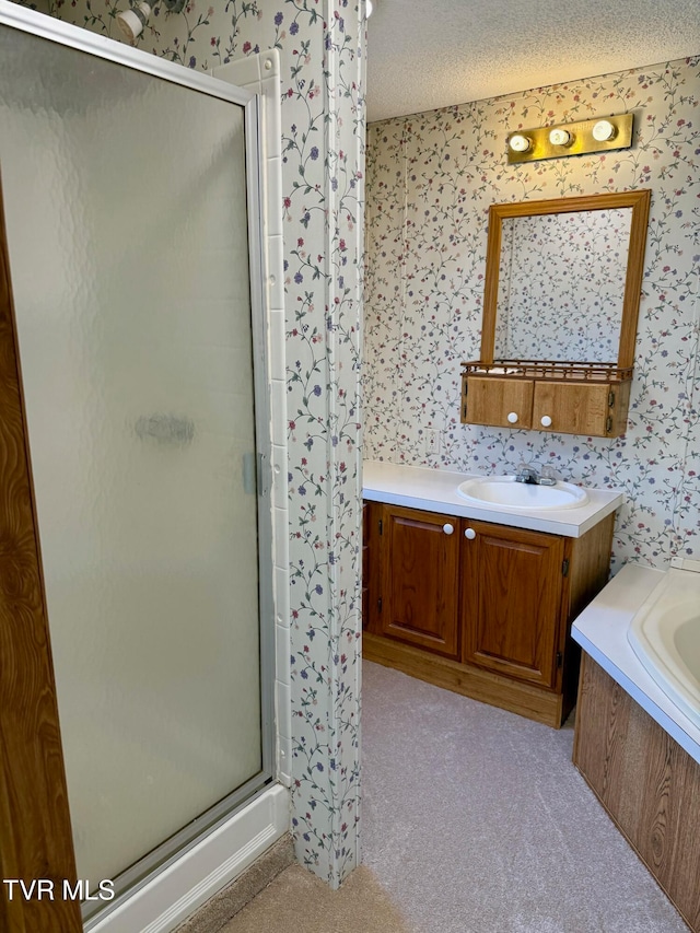 bathroom featuring vanity, plus walk in shower, and a textured ceiling