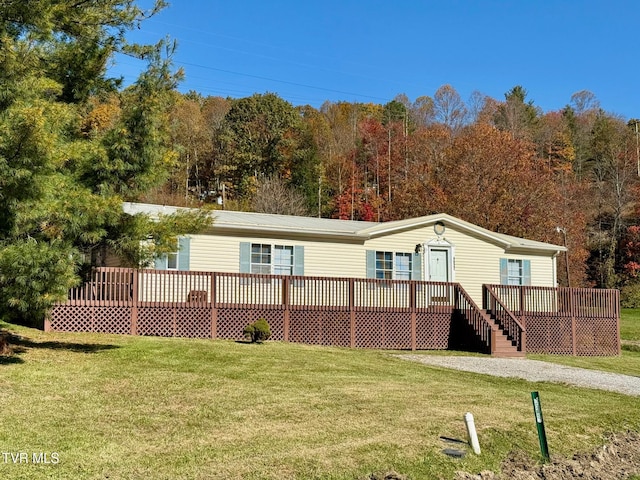 back of property featuring a yard and a deck