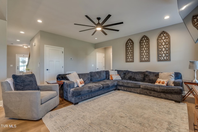 living room featuring ceiling fan and light wood-type flooring