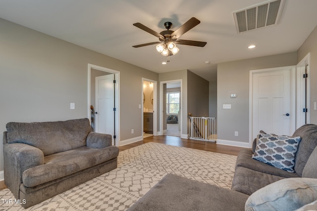 living room featuring light hardwood / wood-style floors and ceiling fan