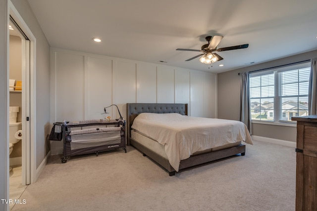 carpeted bedroom featuring connected bathroom and ceiling fan