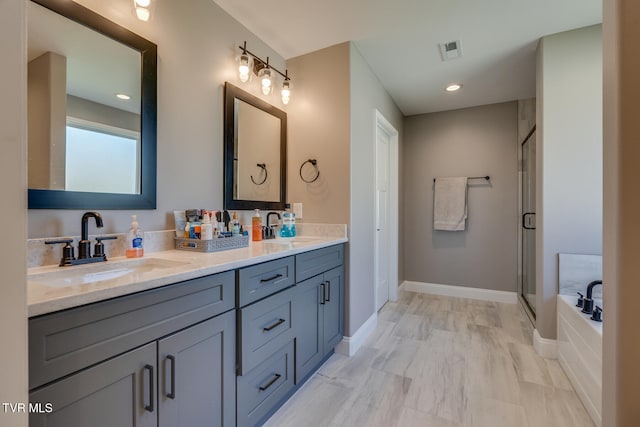 bathroom with vanity and separate shower and tub