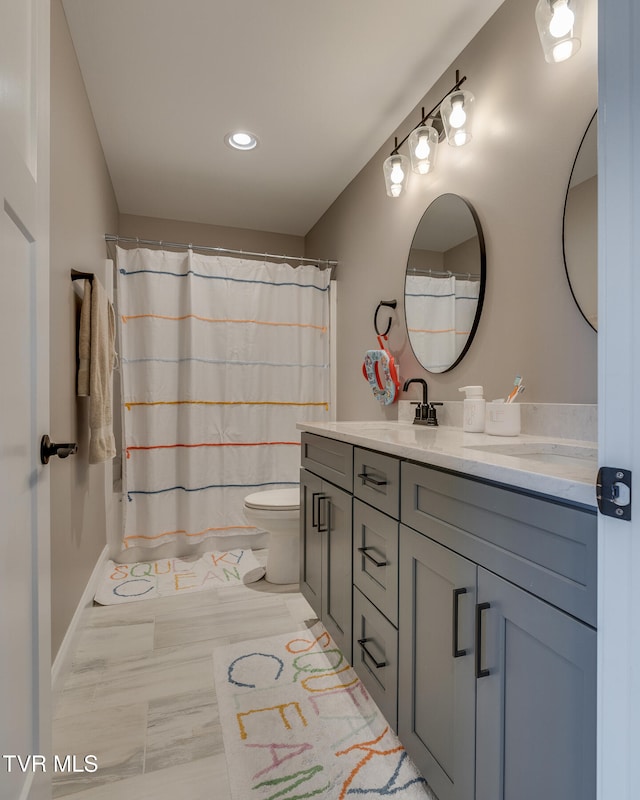 bathroom featuring vanity and toilet