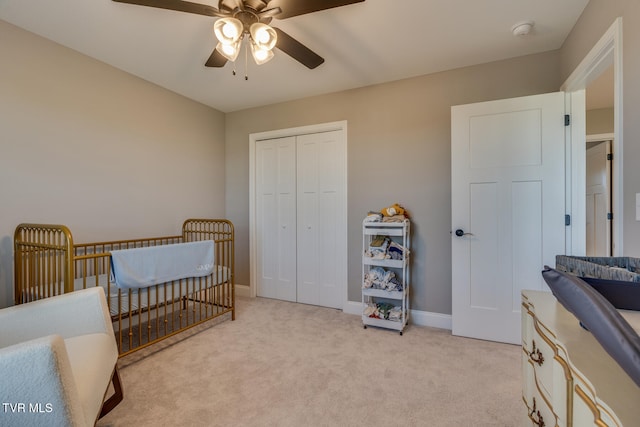 bedroom featuring light carpet, a closet, and ceiling fan